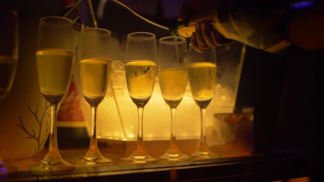 Pouring Champagne in glasses during party