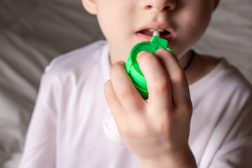 Baby getting medicine through oral spray for sore throat