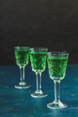 Traditional italian or czech liqueur or bitter with fennel. Three absinthe glass