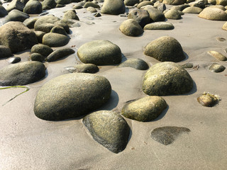 Fototapeta na wymiar Rocks in sand, Rockport Ma