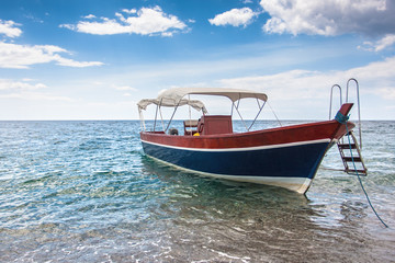 Fototapeta premium Wooden boat on the sicilian beach, Italy