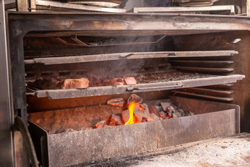 food, craft and delicious concept - cooking steak on a grill