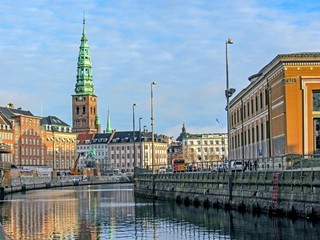 Fototapeta premium City canal and historical buildings of Copenhagen with St. Nikolaj Contemporary Art Center in Church, conspicuous landmark of Denmark