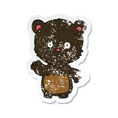retro distressed sticker of a cartoon little black bear waving