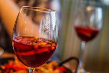 two glasses of red wine in hand
