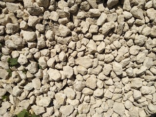 photo of white textured stones with sharp edges on a bright Sunny day