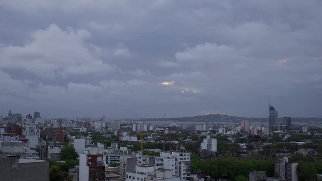Day to night time lapse of fast moving clouds over Montevideo Uruguay port
