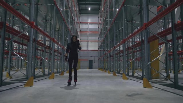 girl on roller skates there is a warehouse and smiling
