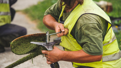  Law mower man fixing grass trimmer
