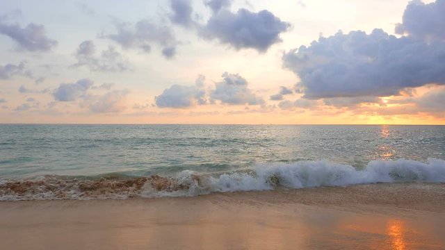 Waves rolling in on the beach during sunset