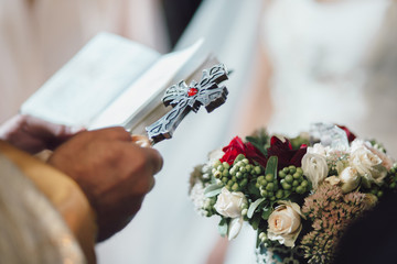 Armenian priest holding the cross durign wedding ceremony