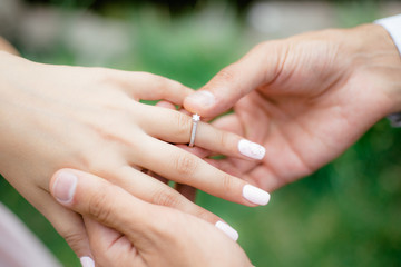 A boy puts engagement ring in nature