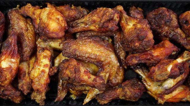 Handheld footage looking down on a large plate of fried chicken shot in 4K 24fps.