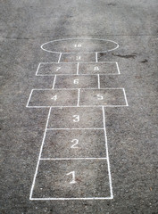 Children's Hopscotch Game on Asphalt City Sidewalk