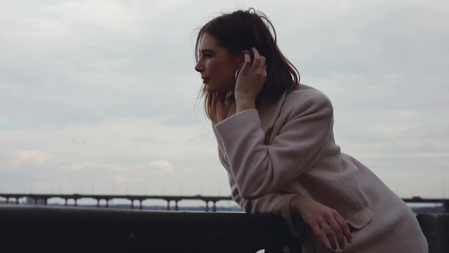 Woman looking forward at river thinking and dreaming outdoors over sky background