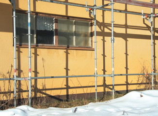 scaffolding at a yellow industrial building