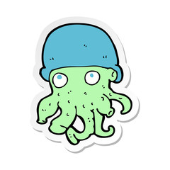 sticker of a cartoon alien head wearing hat