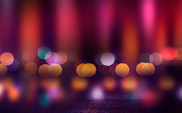 Dark empty stage, multicolored rays of neon searchlight, wet asphalt, smoke, night shooting, bokeh color.