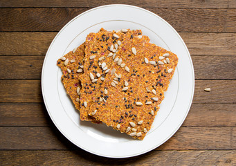 Dehydrated vegan dry raw bread loaves on white dish on wooden table