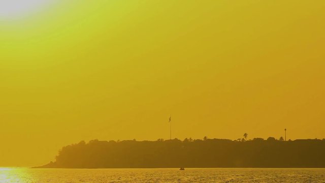 Beautiful silhouette of island with flag during sunset stock video I silhouette of island with flag near a Mumbai city
