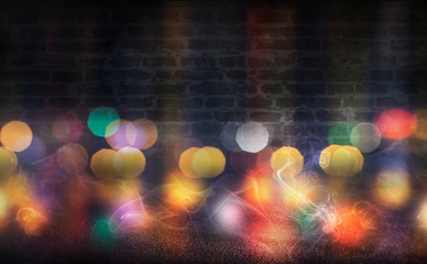 Empty scene background. Empty brick wall, concrete floor, spotlight, multicolored neon rays, bokeh.