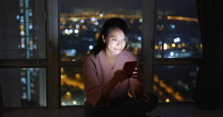 Woman use of smart phone at home in the evening