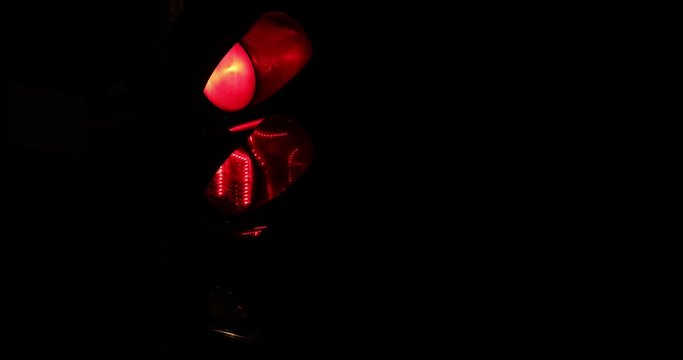 traffic light traffic regulator at a crossroads at night