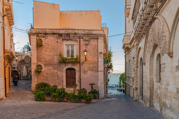 Facade of the building with green plants in Ortigia island, Syracuse, Sicily, Italy