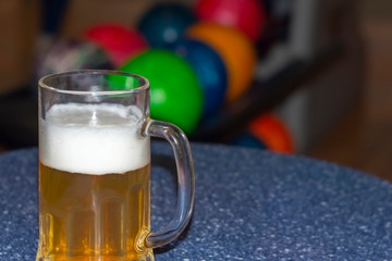 Mug of beer on the table in the bowling center