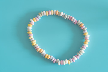 Beads and bracelets of sweets  candy on a turquoise background
