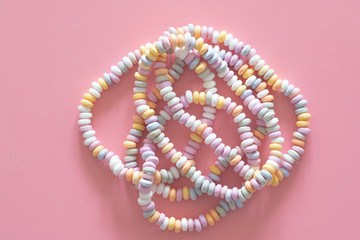 sweets Beads and bracelets candy on a pink background