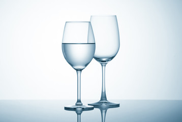 Glasses with water on blue background