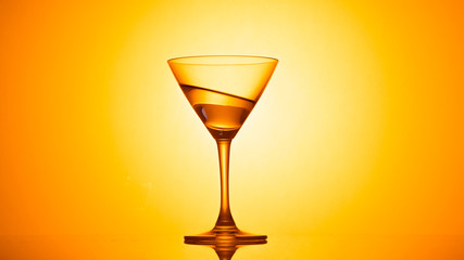 Martini glass on color background
