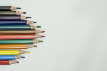 Art and drawing creative concepts of colorful crayon pencils with triangle shape on white background with copy space. Top view, Close-up, For banner design.