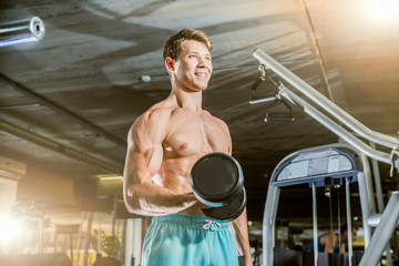 a young guy fitness smiling in the gym