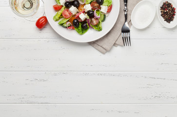 Greek salad plate and white wine
