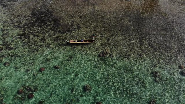 aerial view local Guna poles canoe over reef in San Blas Islands archipelago Panama