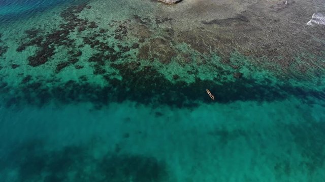 aerial view local Guna poles canoe over reef in San Blas Islands archipelago Panama