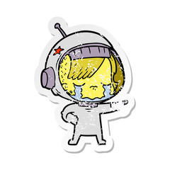 distressed sticker of a cartoon crying astronaut girl