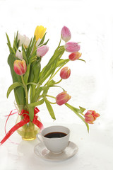 cup of coffee and a bouquet of flowers on a white background, a beautiful morning and the arrival of spring