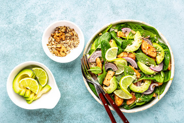 Healthy avocado salad with chicken breast and spinach, flat lay, top view