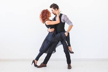 Social dance, bachata, kizomba, tango, salsa, people concept - Young couple dancing over white background
