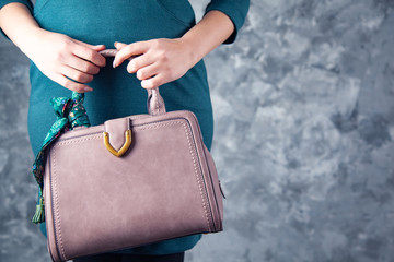 .woman hand bag on dark background