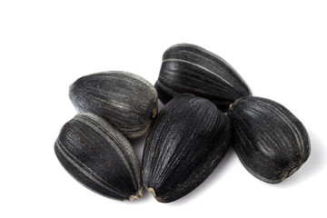 Few black sunflower seeds close up. isolated on a white background.