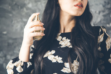 young woman hand holding perfume