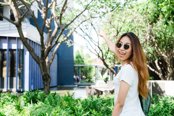Traveler backpacker asian woman travel in Bangkok, Thailand. Happy young female spending holiday trip at amazing landmark and enjoy her journey in traditional city.