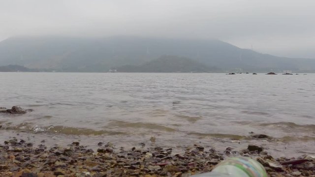 Plastic bottle on the beach. Environmental problem.