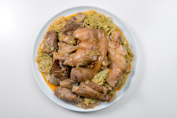 White plate with pork meat and savoy cabbage