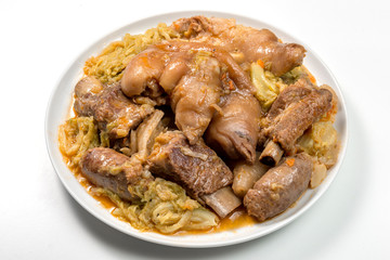 White plate with pork meat and savoy cabbage