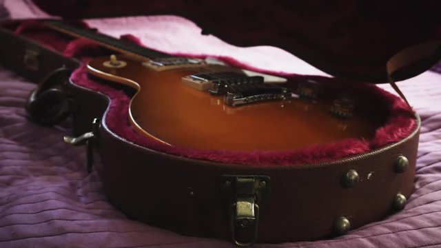 Man opening a guitar leather case